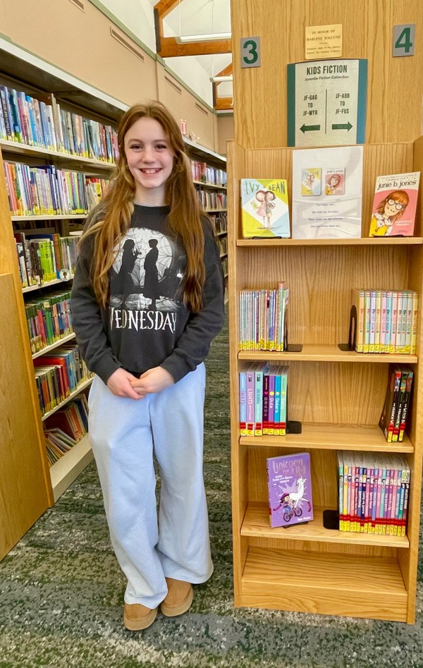 Dylana with her book display at the library.