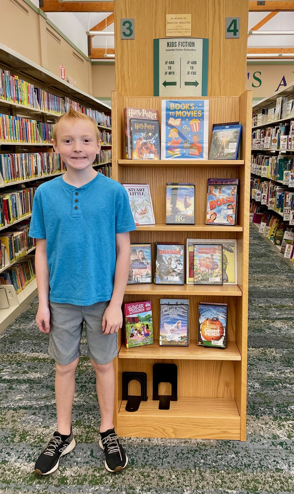 Micah in front of Book Display